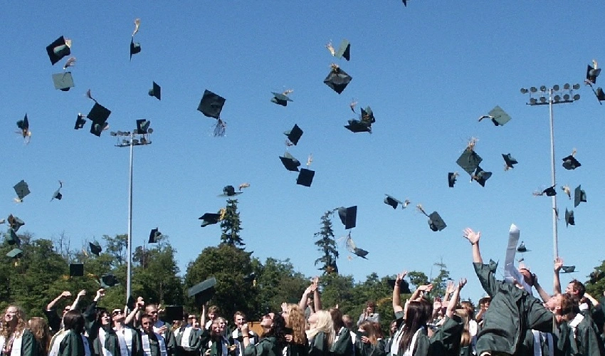 Graduation caps being thrown in the air