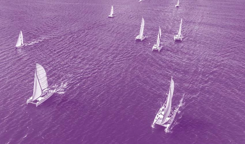 Ships sailing on the ocean with purple overlay