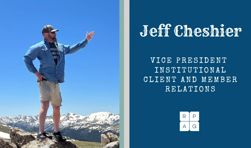 Jeff Cheshier on a mountain gesturing to his name and title