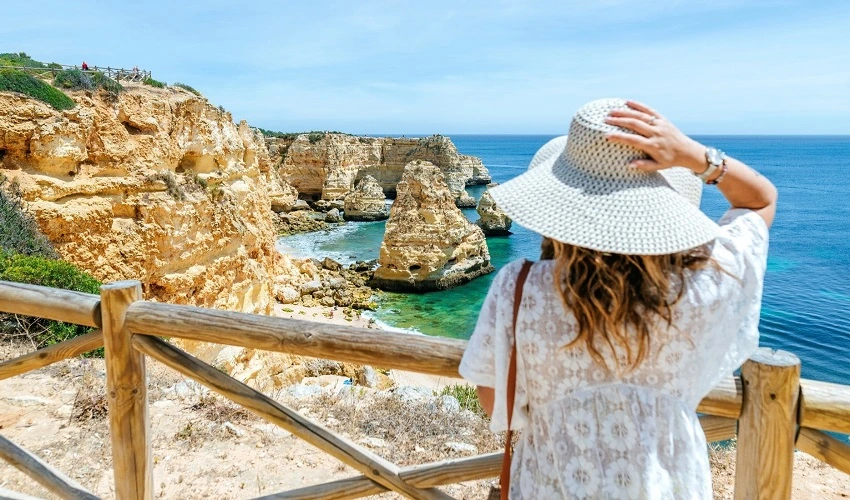 Woman looking at a view of rocky structures in the ocean