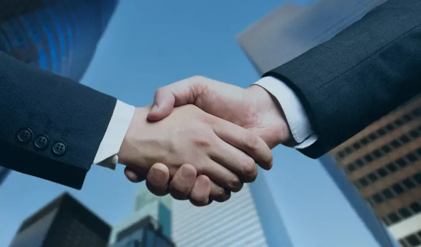 Handshake outside in front of buildings