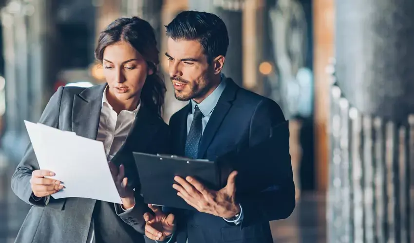 man and woman looking at a clipboard