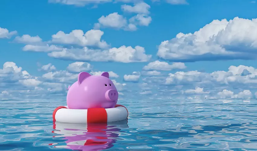 Piggy bank on floaty in water