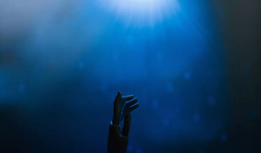 Robot Hand Reaching into Blue Light