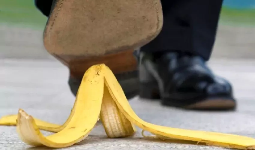 Shoe stepping on banana peel