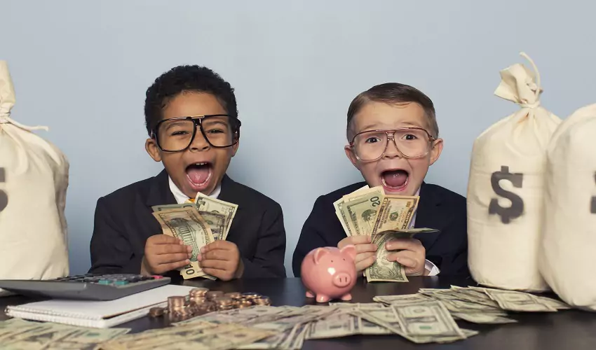 Two kids surrounded by and holding money screaming