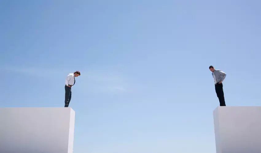 Two men standing on the edge with gap