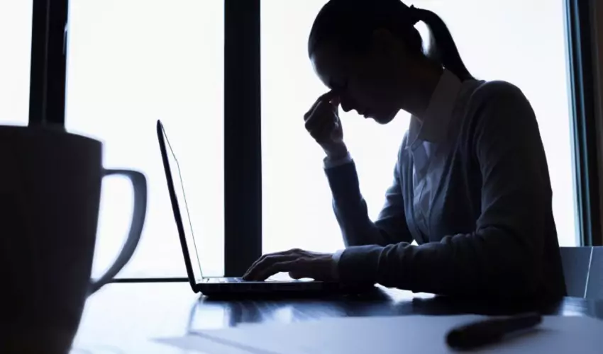Woman stressed in front of computer